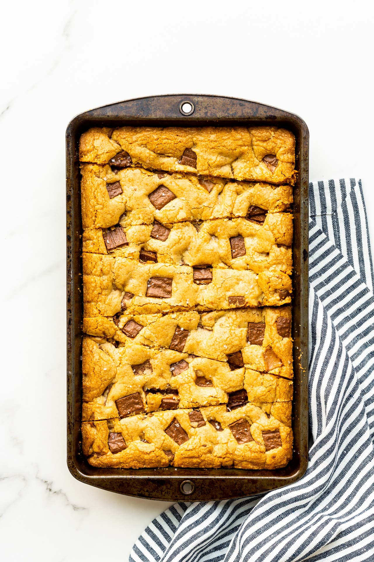 Skor blondie bars baked in a rectangular pan and cut into triangular strips