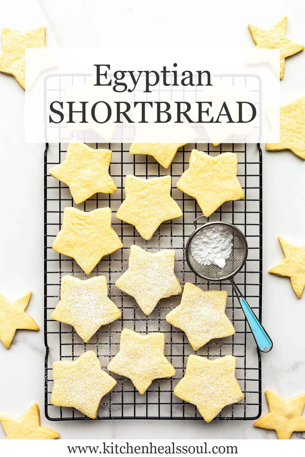 Star cookies on a black cooling rack being sprinkled with icing sugar.