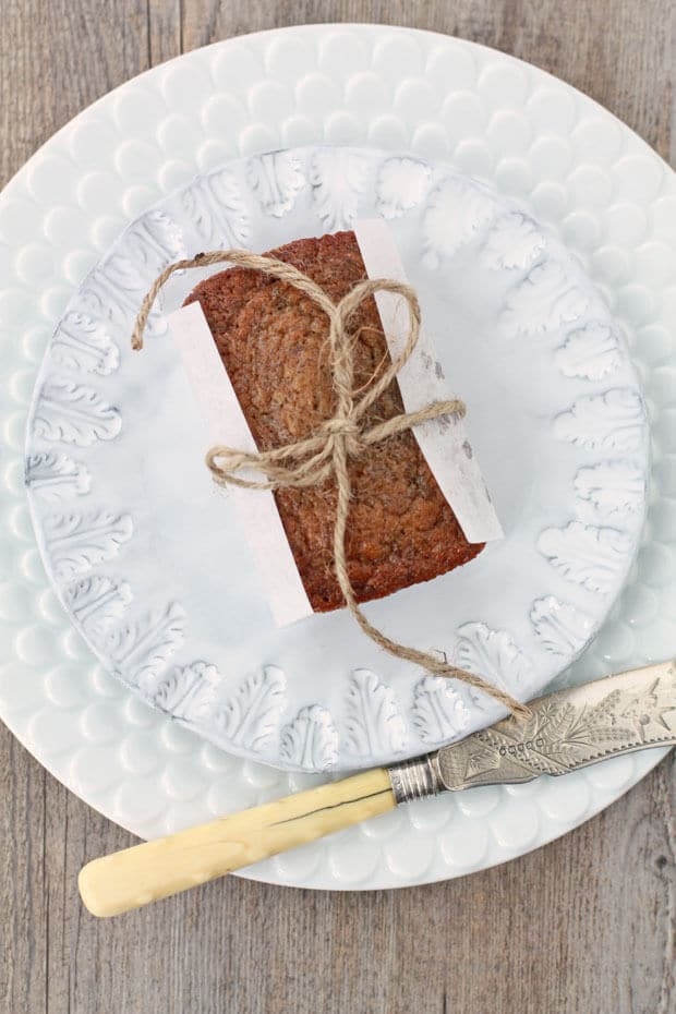 Top view of mini banana bread loaf wrapped in parchment tied with string