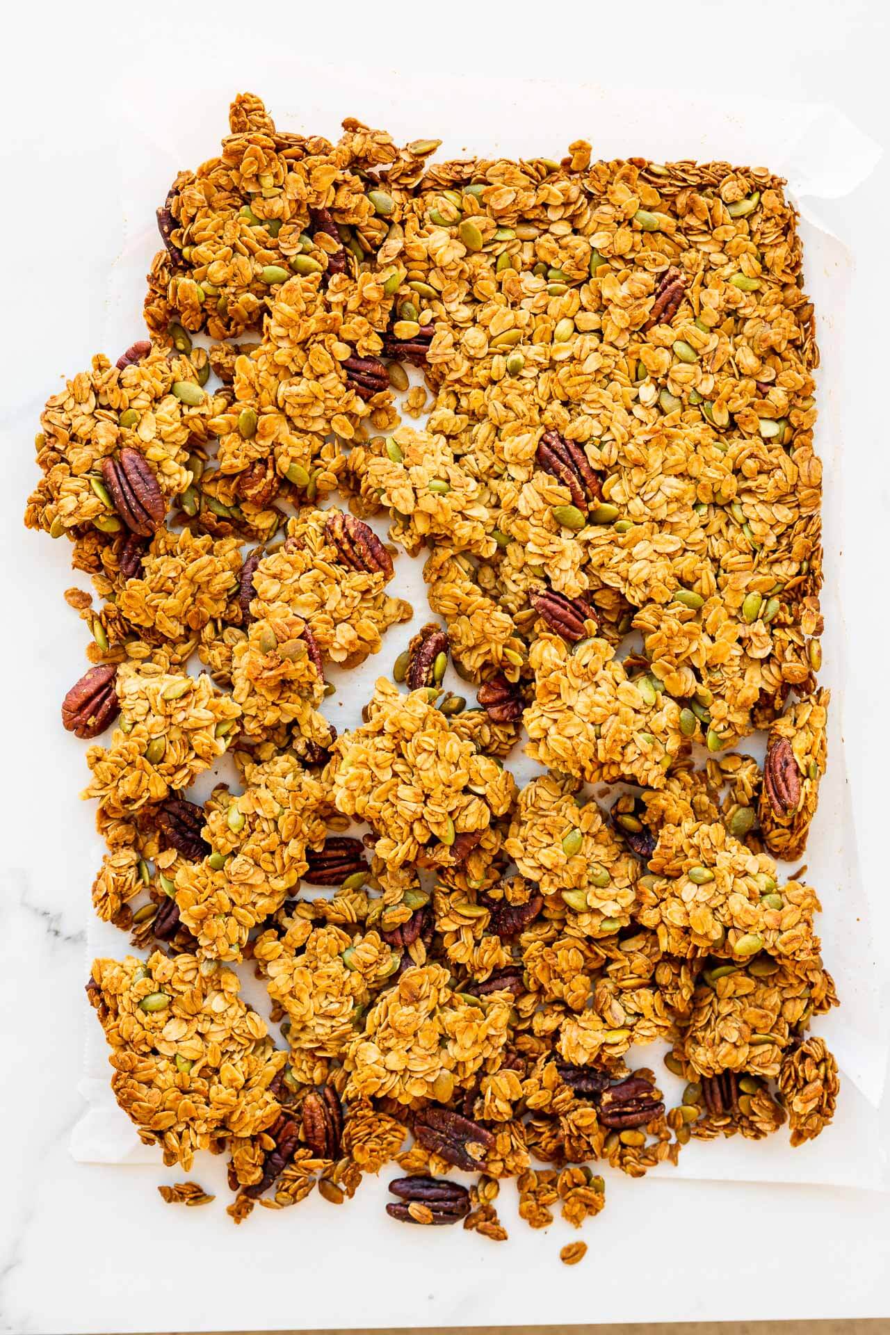 Breaking a sheet of granola into clusters