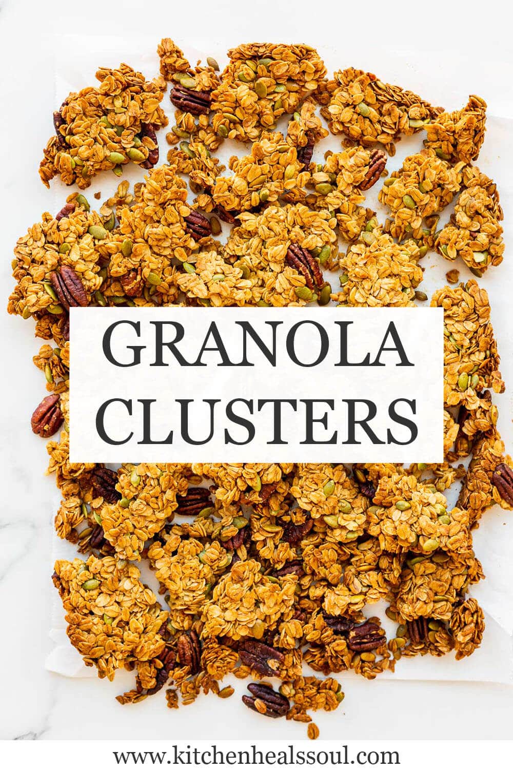 Homemade granola clusters broken into big pieces on parchment paper