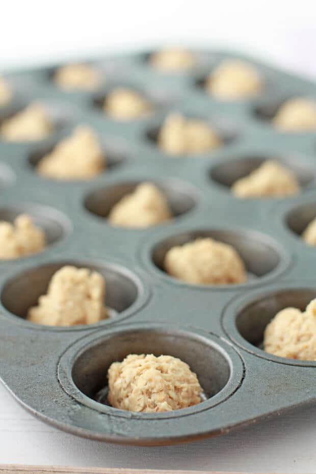 Oatmeal cookies and glass of milk, photo shot from overhead to show perfect round shape of cookies that were baked in a mini muffin pan.