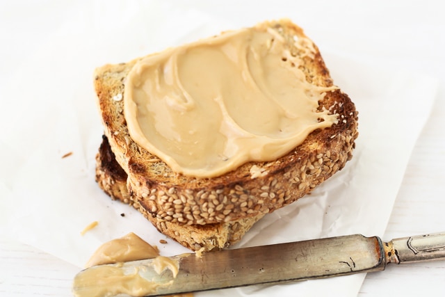 Homemade maple butter and toast smeared with a knife