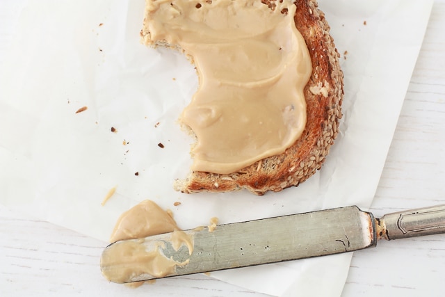 Homemade maple butter smeared on toast with a knife