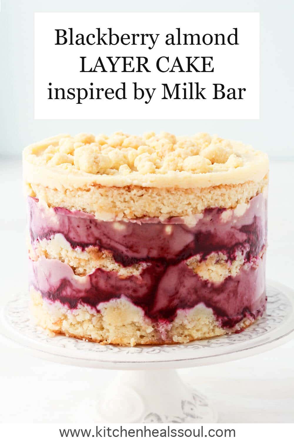 Milk Bar style naked cake featuring layers of almond cake, almond frosting, blackberry lemon curd, and blackberry purée for a stunning purple and creamy beige layer cake