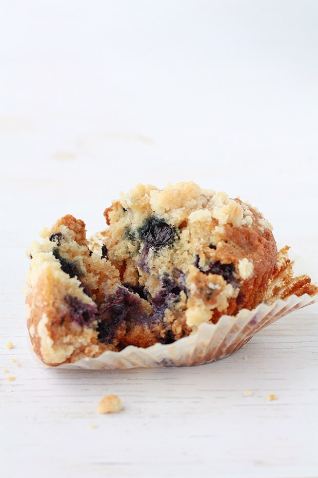 Honey blueberry muffin with crumble topping opened up to show inside