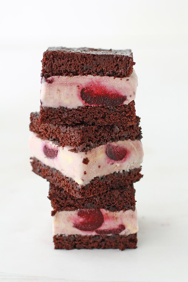 Stack of homemade ice cream sandwiches with bourbon cherry ice cream (three) and you can see the whole cherries in ice cream layers.