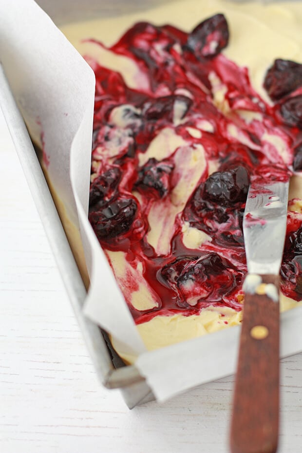 Swirling bourbon cherries in vanilla bean ice cream swirl