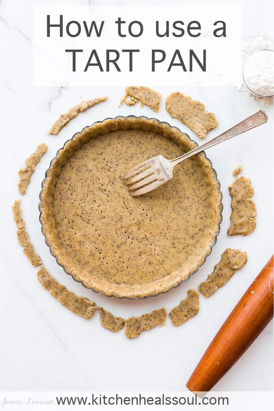 A tart pan with tart dough fitted inside and a fork to prick the pastry to allow air and steam to escape during blind baking