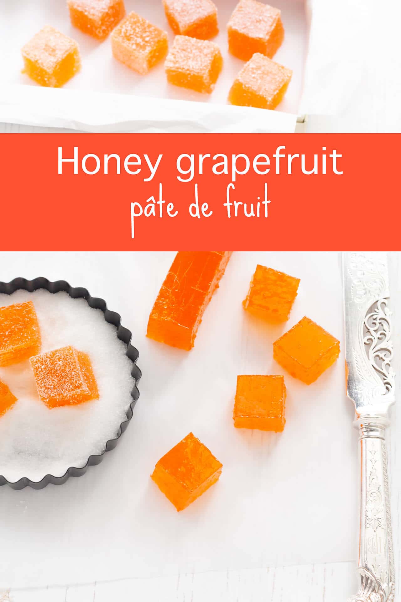 Cutting homemade grapefruit pâte de fruit with a large knife, then dipping cubes of pâte de fruit in fine granulated sugar to coat the candy on all sides before serving