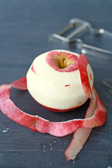 Peeling apple with an apple peeler.