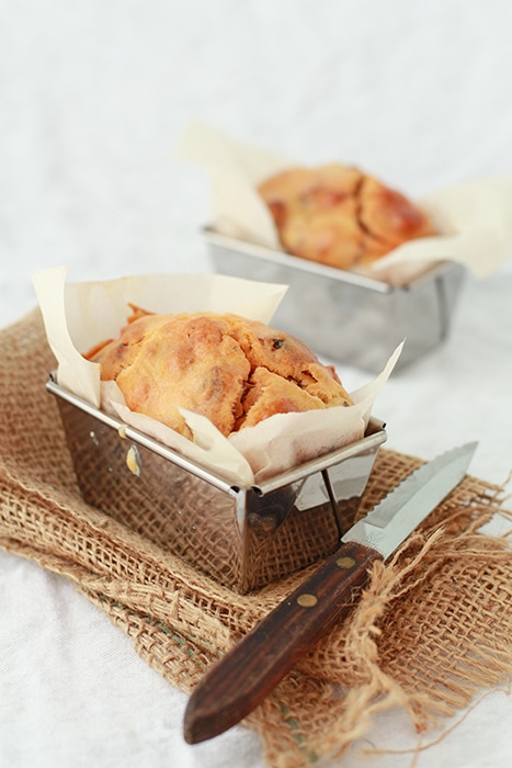 savory date and chorizo loaf baked in mini loaf pans, with serrated knife to slice and serve