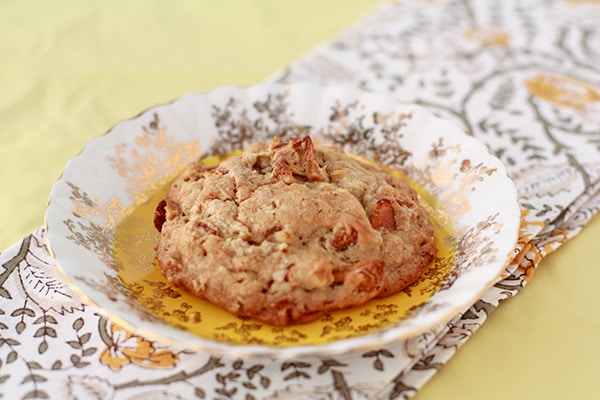 Thick bacon apple oat cookie on a fancy plate with floral napkin