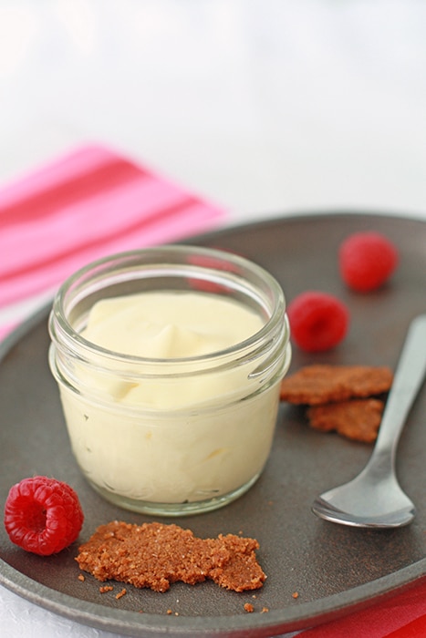 Lemon mousse served in a small jar with graham cracker crumble and berries