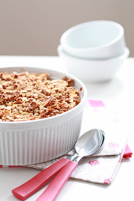 Freshly baked mango crisp with red spoons