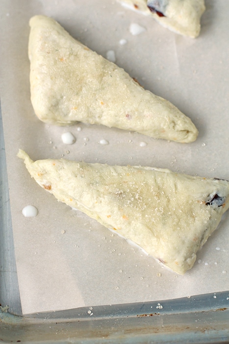 Scone dough cut into triangles or wedges and brushed with cream before baking