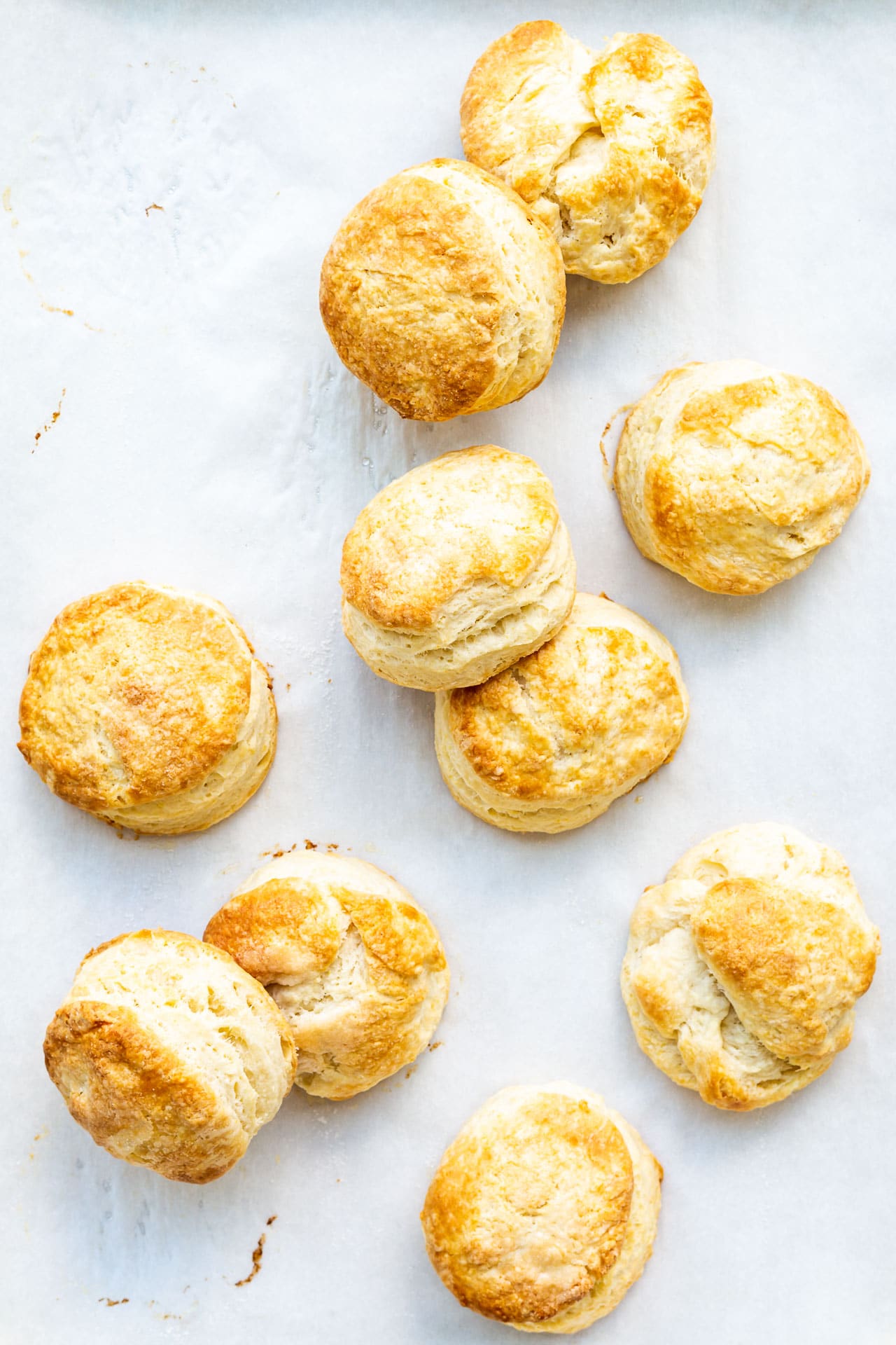 Golden brown homemade biscuits freshly baked on parchment paper