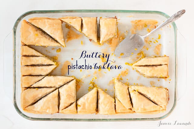 Pistachio baklava cut into a star pattern with two thirds of the pieces removed