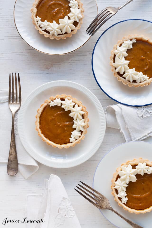 Little pumpkin tarts on white plates