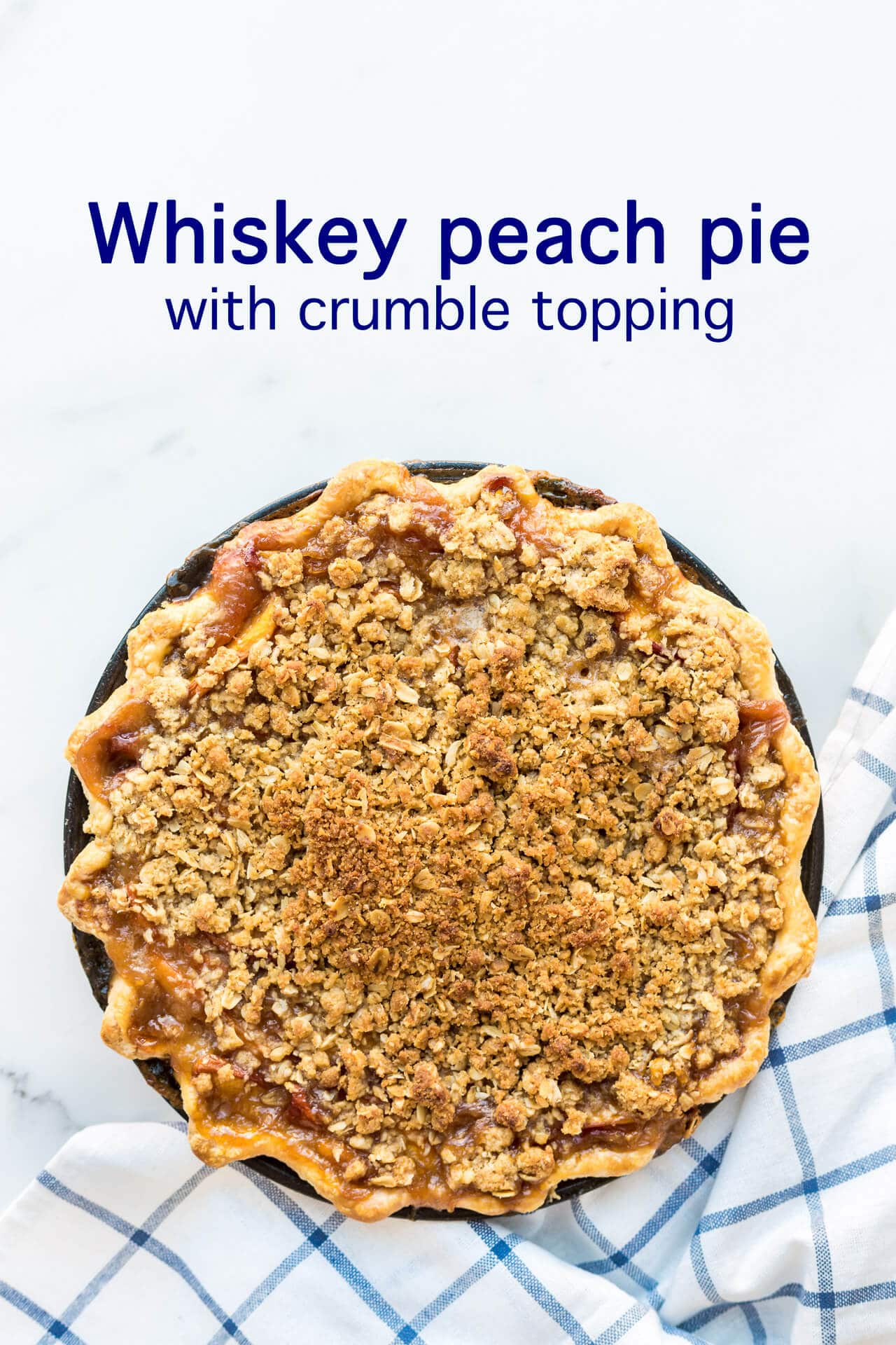 Whiskey peach pie with crumb topping and a crimped edge