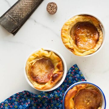 Apple clafoutis sweetened with maple & a little nutmeg - it's like a baked custard with apples. Totally comforting and perfect dessert for apple season and fall.Apple clafoutis sweetened with maple & a little nutmeg - it's like a baked custard with apples. Totally comforting and perfect dessert for apple season and fall.