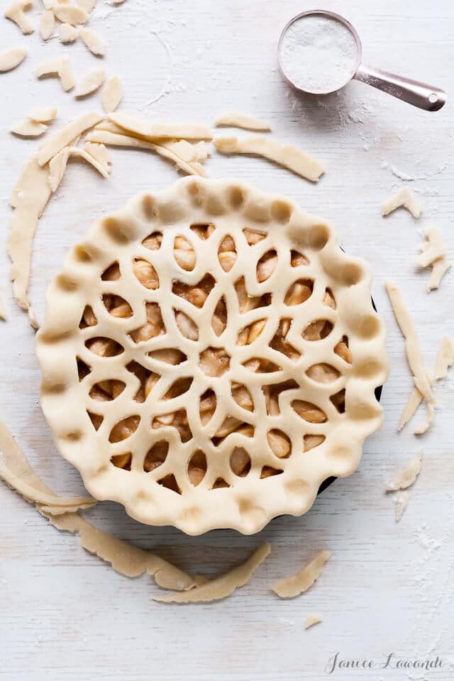 Apple pie ready for the oven with decorative pie crust.