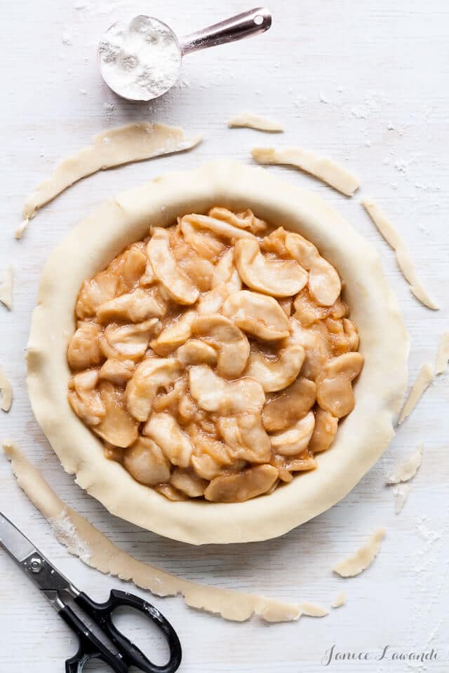 Filling the apple pie with roasted apple slices.