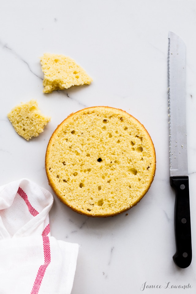 Levelled cake sliced open with a serrated bread knife to reveal the inside crumb.