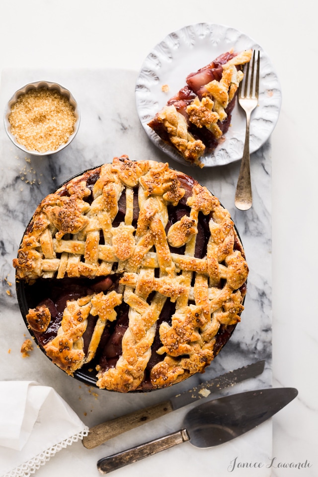 red wine-poached pear pie made with an all-butter flaky pie crust, sliced