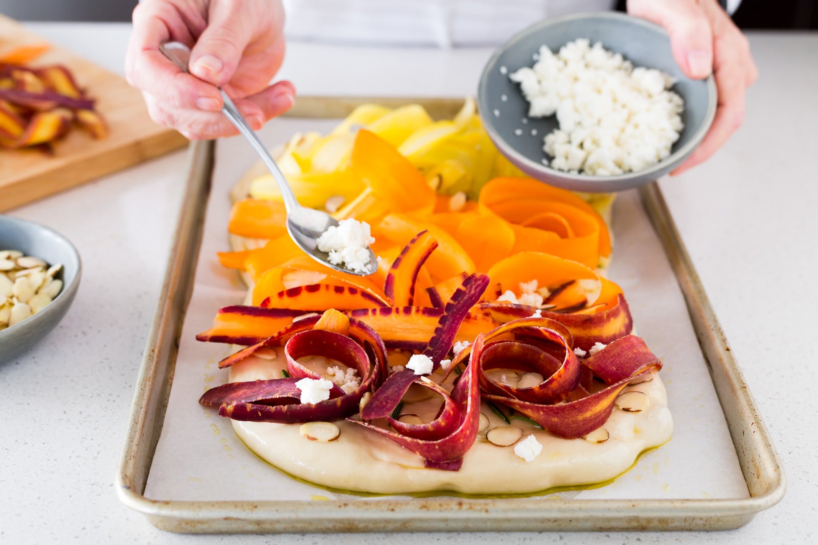 sprinkling-cheese-on-carrot-focaccia-before-baking