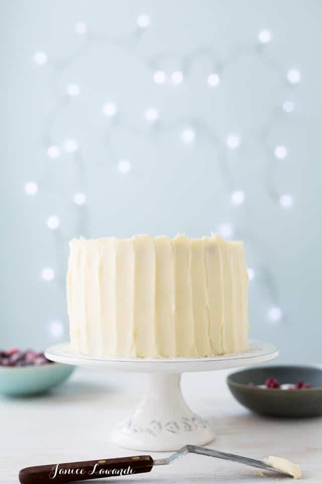 Cranberry cardamom cake with cream cheese frosting and sugared cranberries