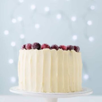 Cranberry cardamom cake with cream cheese frosting and sugared cranberries