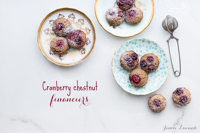 Cranberry chestnut financiers dusted with powdered sugar and served on vintage plates