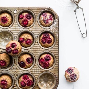 Dust cranberry chestnut financiers with powdered sugar