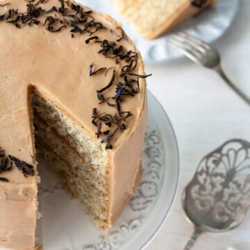 This Earl grey tea cake is a layer cake infused with Earl Grey tea. Earl Grey tea is used in the cake layers, in the Earl Grey frosting, and in the garnish.