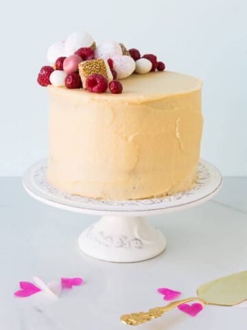 Sweet sesame layer cake with raspberries - this is a layer cake recipe flavoured with sesame butter (tahini), raspberries, and a little honey. Makes a beautiful birthday cake for adults.
