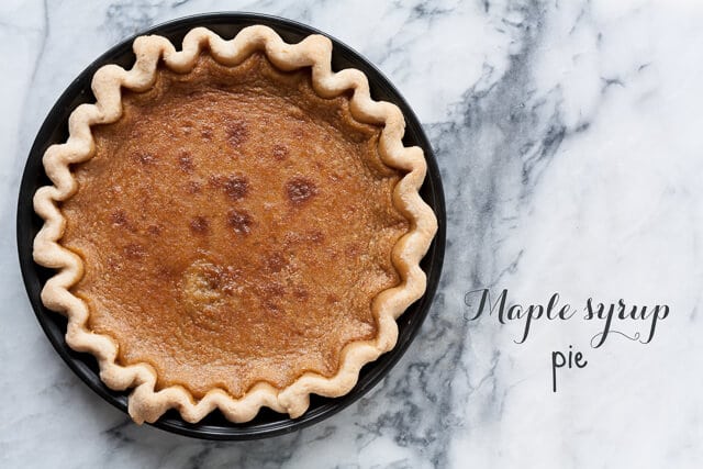 Maple pie with a crimped crust in a dark metal pie pan