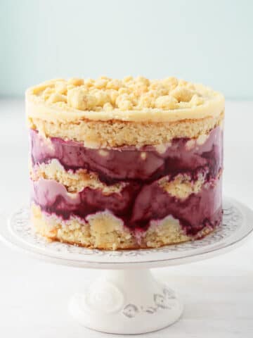 Milk crumbs on a Momofuku Milk Bar style cake-layers of blackberry curd, almond cake, and almond frosting