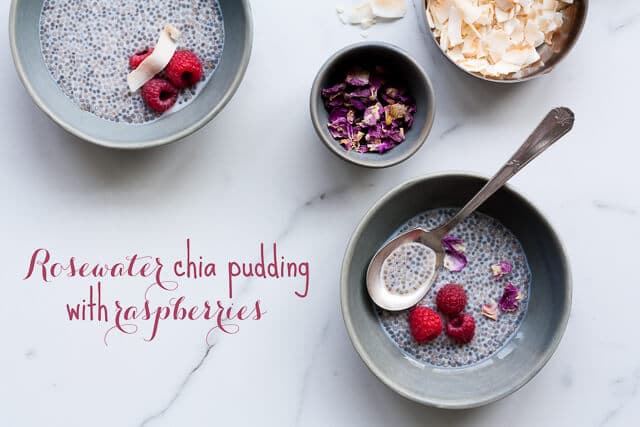 Bowls of chia pudding with fresh raspberries, coconut flakes, and dried rose petals