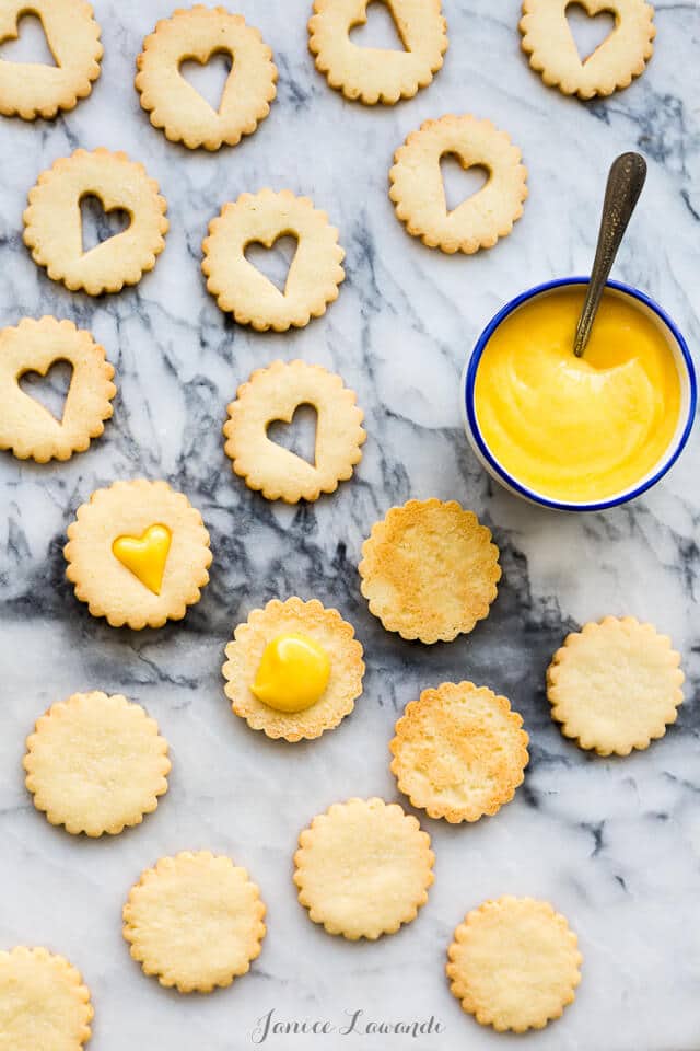 Sandwiching coconut cookies with grapefruit curd