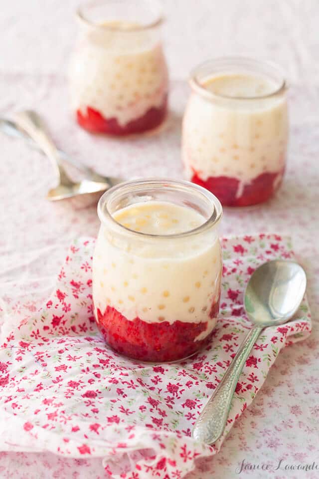 Vanilla cardamom tapioca pudding with strawberries served in mini glass jars