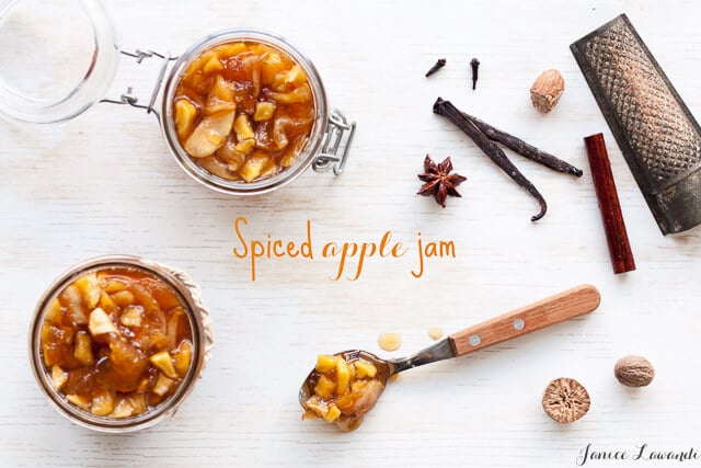spiced apple jam in jars with dried spices and a nutmeg grater