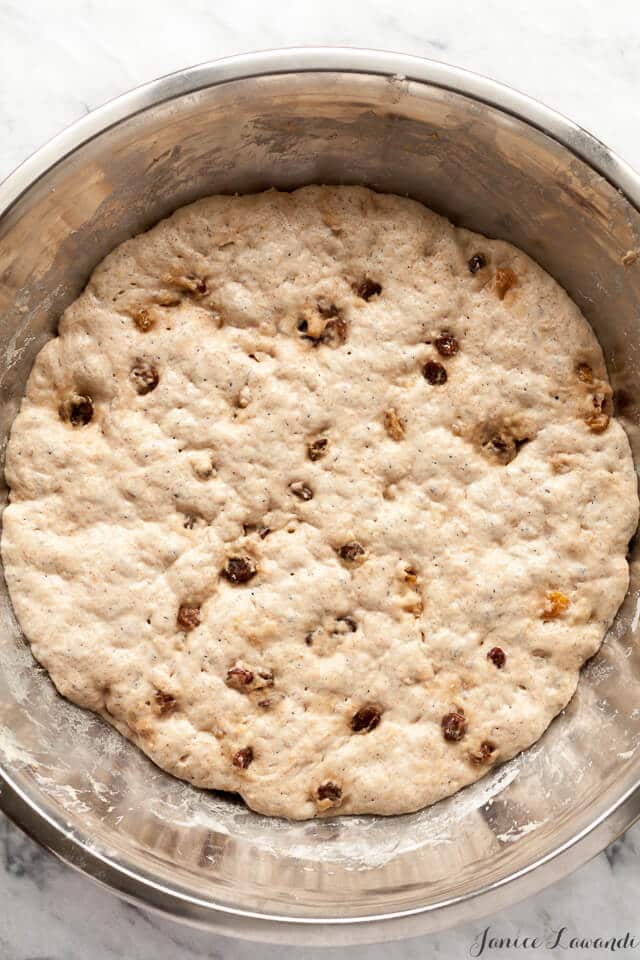 the dough for cinnamon raisin no knead bread in a stainless steel bowl