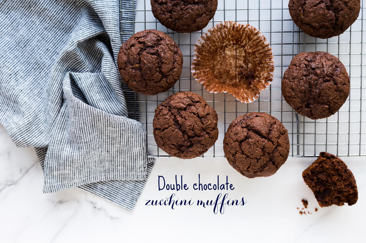 Chocolate zucchini muffins with Cacao Barry chocolate on a cooling rack with a striped linen