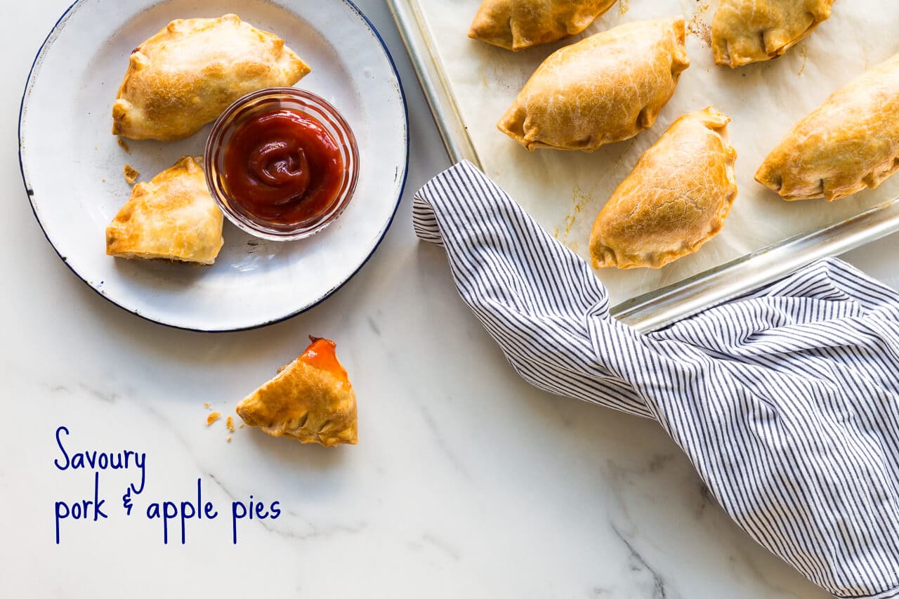 Savoury pork and apple pies with shredded pork, thyme, and apple chunks served with ketchup