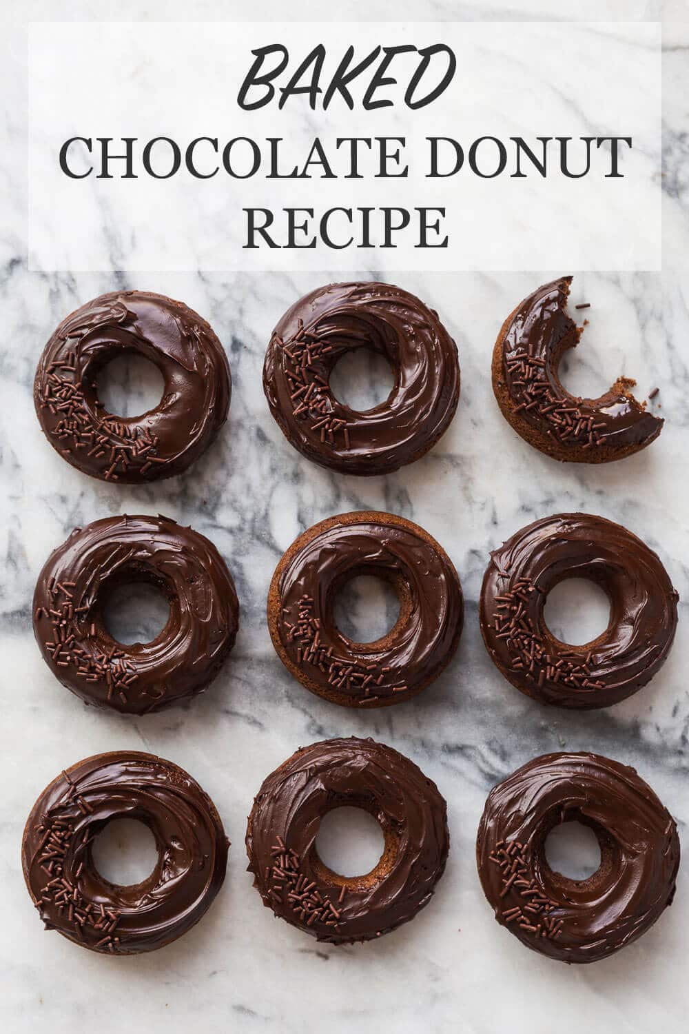 nine double chocolate donuts that are chocolate cake donuts topped with chocolate ganache glaze and chocolate sprinkles