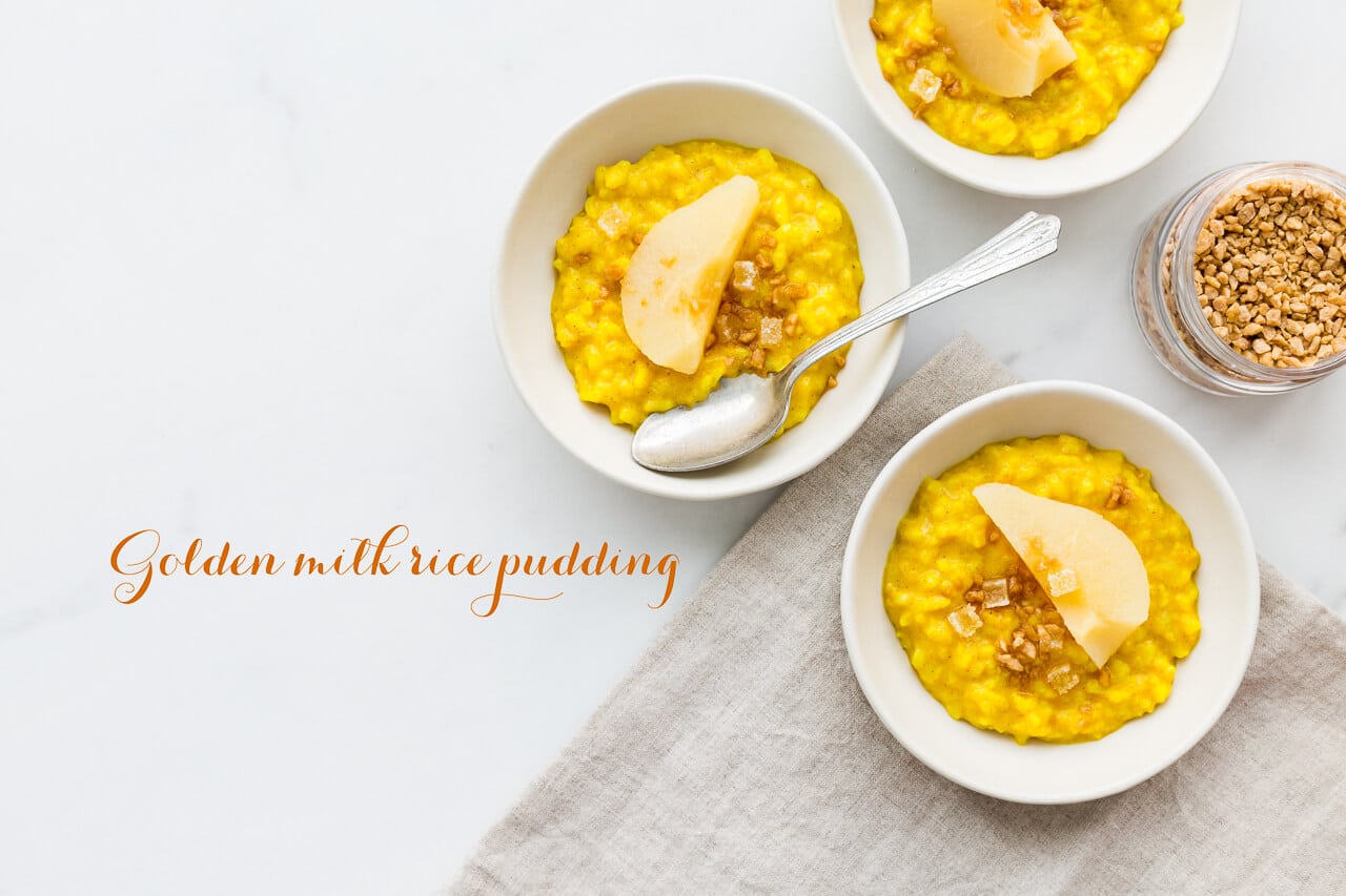 Golden milk rice pudding made with leftover rice and spiced with turmeric, ginger, cardamom, and cinnamon, served with poached pear