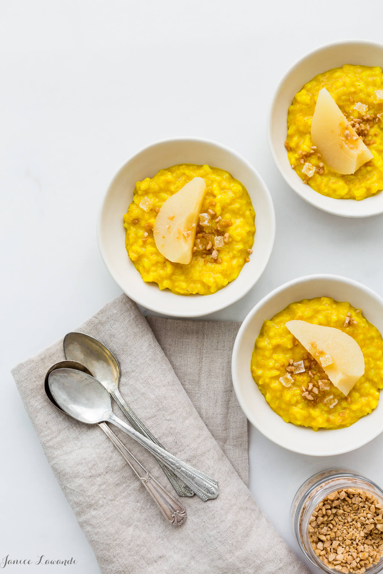 Golden milk rice pudding spiced with turmeric, ginger, cardamom, and cinnamon served with poached pears