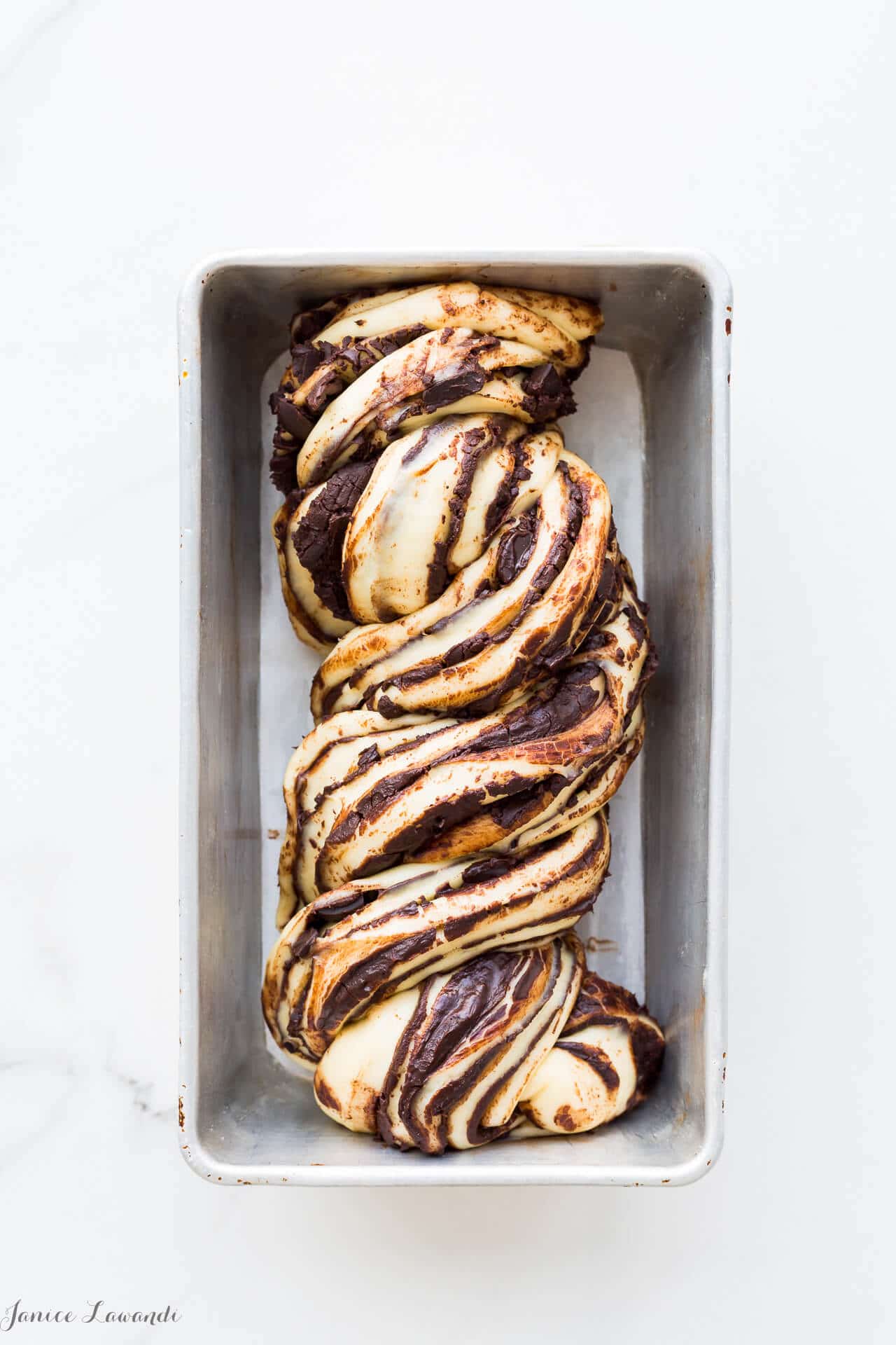 A loaf of homemade swirled cinnamon chocolate babka ready to be baked in the oven