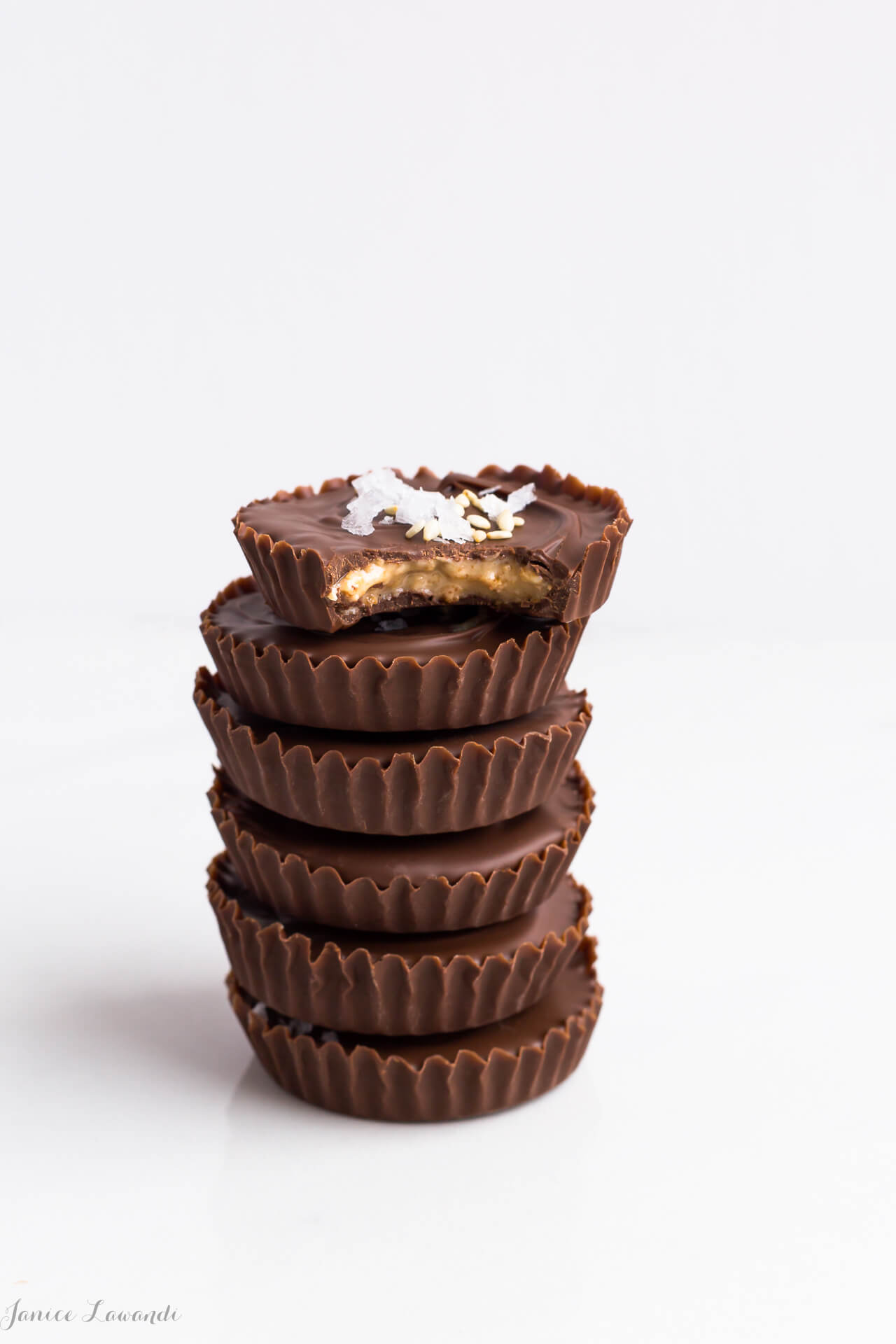 A stack of homemade chocolate sesame butter cups, just like peanut butter cups but with tahini instead of peanut butter